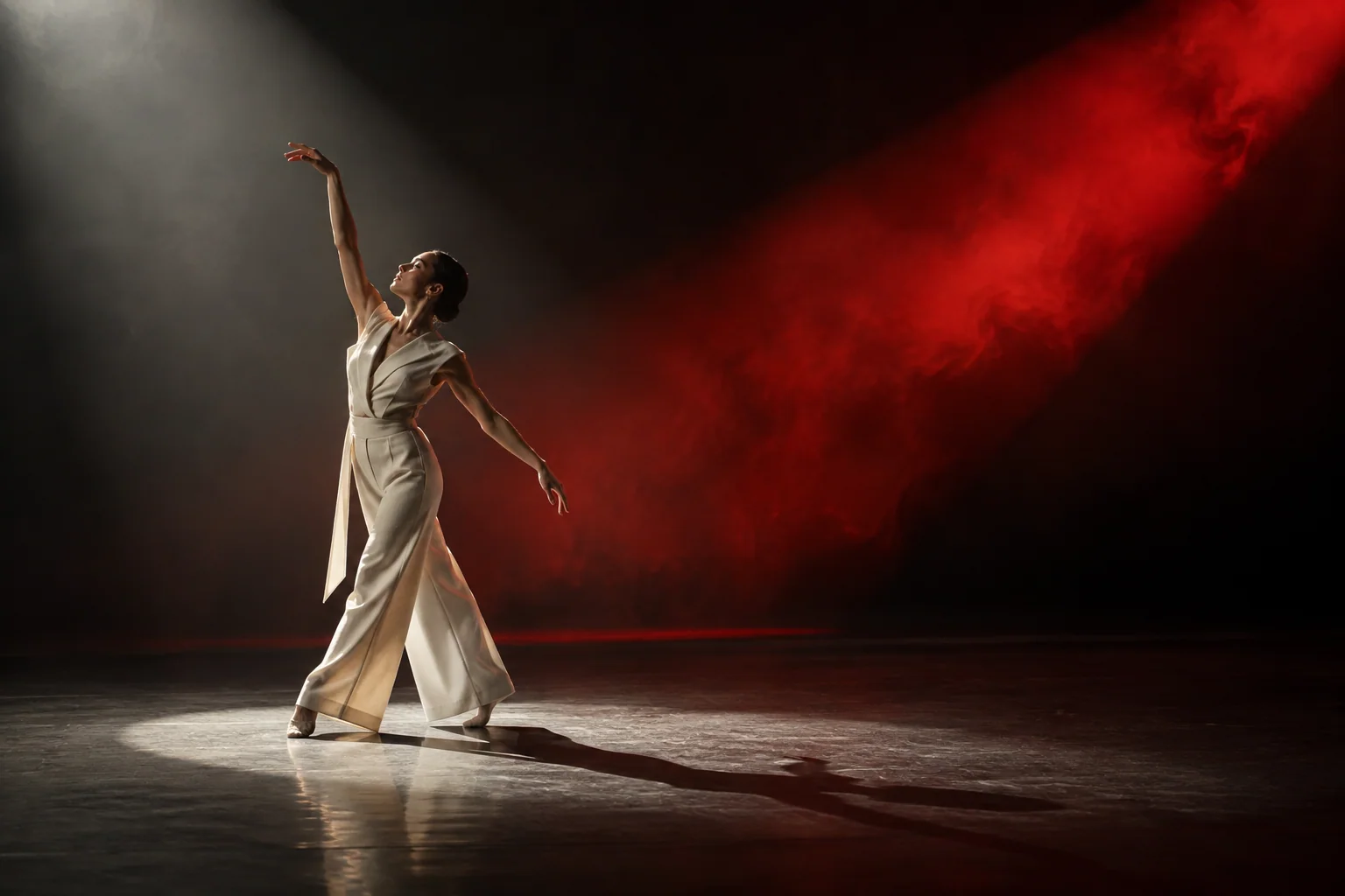 A performer framed by a dramatic scarlet spotlight in a film studio